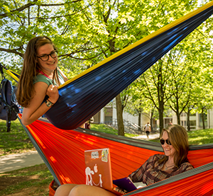 Two female students relaxing in hammocks