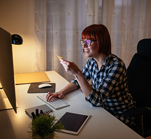 Student at computer smiling